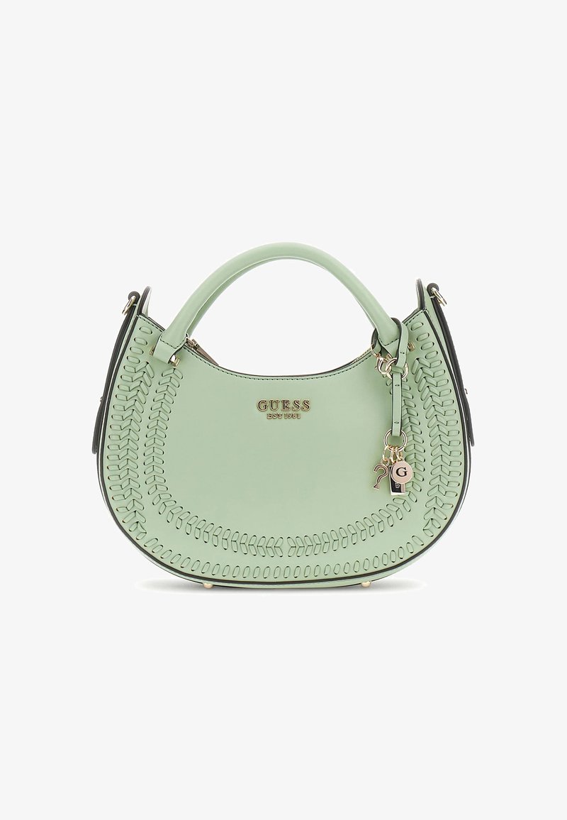 Menta zöld táska, kerek formával, díszvarrással, arany kiegészítőkkel, kulcstartó díszítéssel és fekete oldalsó részletekkel.