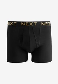 Boxer-briefs en coton noir avec une ceinture élastique dorée affichant le nom de la marque "NEXT" en lettres répétées. Présentent une texture lisse.