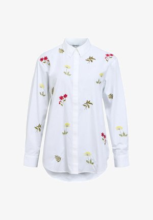 Chemise à col blanc avec broderie florale en rouge, jaune et vert. Manches longues et ourlet arrondi. Fabriquée en tissu de coton.