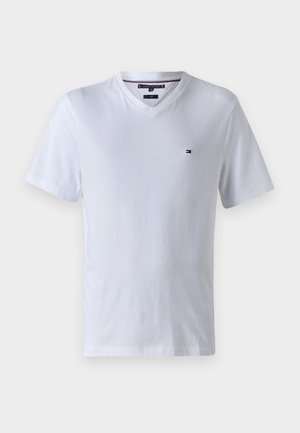 White short-sleeve V-neck T-shirt with small Tommy Hilfiger logo on left chest and branded collar tag.