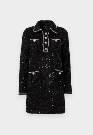 Black sequined dress with a collared neckline, five button front, and two pockets, featuring silver trim and round embellishments.