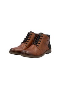 Bottines en cuir marron avec des accents noirs, présentant un bout arrondi, un laçage, une semelle en caoutchouc texturé et des détails de couture.