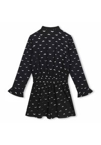 Vestido negro con mangas largas, cintura elástica, puños acampanados y estampado de medias lunas blancas; textura suave y falda acampanada.
