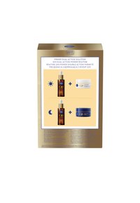 NIVEA Q10 Dual Action skincare set in a gold box. Includes a brown serum bottle and two cream jars, one white and one blue.