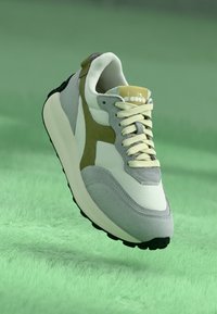 Gray and white sneaker with olive green accents, featuring a smooth leather and suede upper, round laces, and a black rubber sole.
