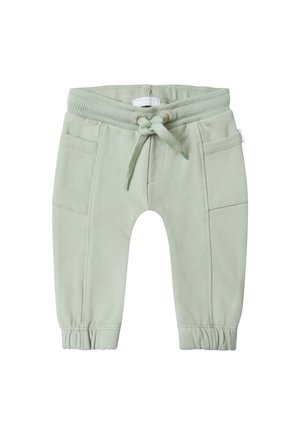 Pantalons de survêtement en coton vert clair, avec une taille élastique, un cordon de serrage ajustable et deux poches avant avec des poignets froncés.