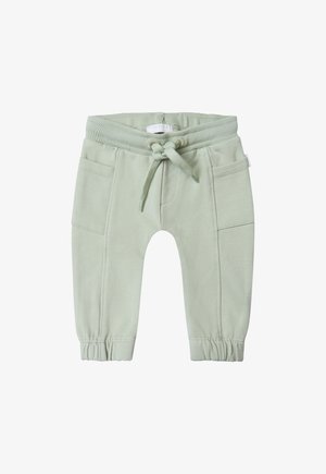 Pantalones de chándal de algodón de color verde claro, con cintura elástica, cordón ajustable y dos bolsillos frontales con puños fruncidos.