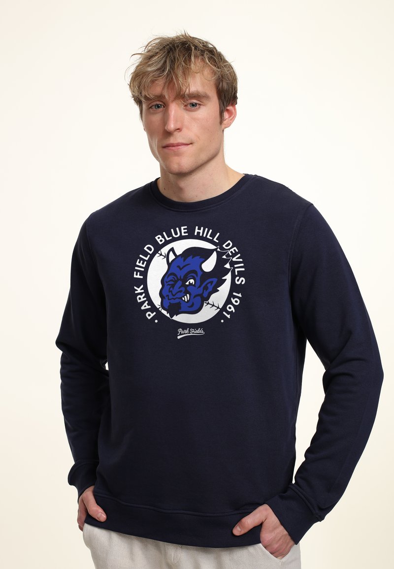 Felpa blu navy in misto cotone, con una stampa grafica rotonda che presenta una mascotte di diavolo blu e bianco e del testo, polsini e colletto a costine.
