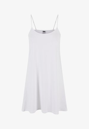 White cotton slip dress with thin adjustable straps, a relaxed fit, and a gently flared hem. Smooth texture, simple design, no visible patterns.