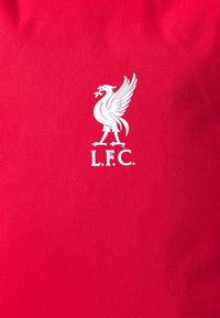 Red fabric features a prominent white Liverpool Football Club logo with a stylized bird and "L.F.C." text beneath.
