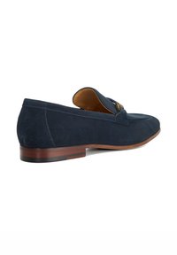 Navy blue suede loafers with a low wooden heel, featuring a tonal accent across the upper and a smooth interior lining.
