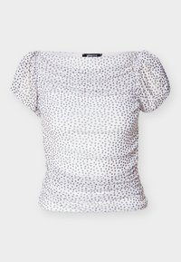 Λευκή μπλούζα με έξω τους ώμους και ανοιχτό μωβ πουά. Διαθέτει μαζεμένο ύφασμα στο μπροστινό μέρος και κοντά φουσκωτά μανίκια για εφαρμοστή σιλουέτα.