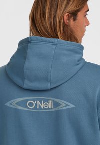 Hooded sweatshirt in blue cotton blend, featuring embroidered "O'Neill" logo in white within a light blue oval design on the back.
