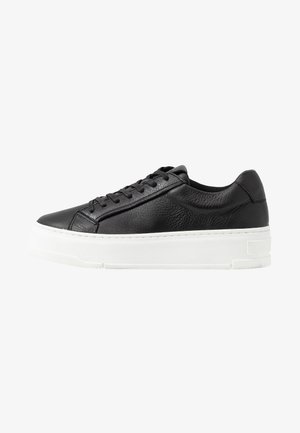 Black leather sneaker with textured surface, white rubber sole, rounded toe, and lace-up design. Features stitching accents and smooth tongue.