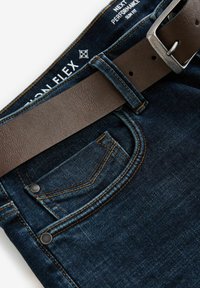 Dark blue denim jeans with a brown leather belt. Features contrasting stitching, rivets, and a small front pocket. Flat lay presentation.