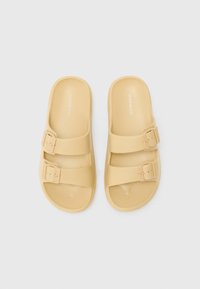 Yellow slide sandals with two adjustable straps, made of smooth synthetic material, featuring a minimalist design and flat soles.