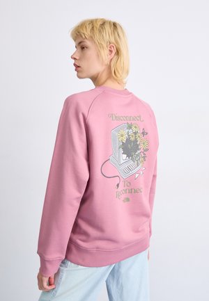 Lyserød sweatshirt med et computer-grafikdesign med blomster, teksten "Disconnect to Reconnect" og ribbede manchetter og forkant. Blød stofstruktur.