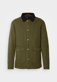 Veste vert olive avec un col en velours côtelé brun foncé, dotée de deux poches frontales et de fermetures à boutons-pression. Confectionnée en tissu durable.