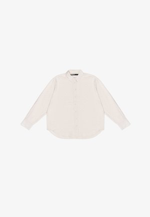 Svetlo béžová košeľa s dlhým rukávom a golierom, so subtílnymi bodkovanými vzormi, zaobleným lemom a zapínaním na gombíky. Hladký textil príjemný na dotyk.
