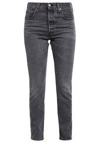 Mustat suorat farkut denimiä, joissa korkea vyötärö, viisi taskua ja napillinen etulista. Minimihäivytys, ei kuvioita.