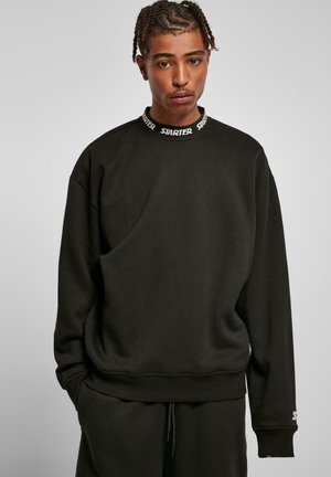 Schwarzer Sweatshirt mit Rundhalsausschnitt und elastischen Bündchen. Verfügt über einen markierten Kragen und eine lockere Passform. Sanfte Textur, schlichtes Design.