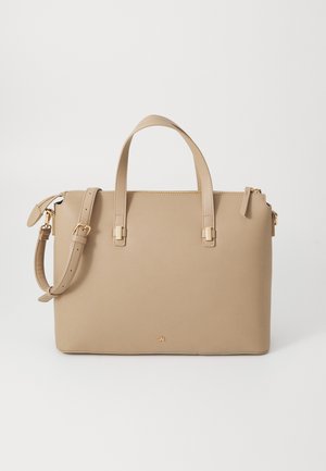 Beige leather handbag with dual handles, detachable shoulder strap, gold hardware accents, and a zip closure. Smooth texture and structured shape.