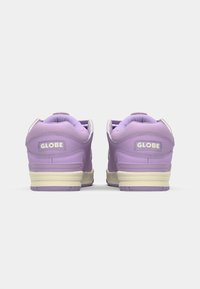Purple sneakers with padded collar and tongue, featuring a contrasting cream outsole and “GLOBE” logo on the heel. Smooth texture.
