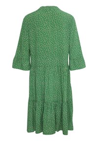 Zelené šaty vyrobené z lehké látky, s béžovým puntíkovaným vzorem, volánkovými rukávy a vrstveným designem sukně.