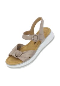 Sandal de ante beige con un detalle frontal retorcido. Cuenta con una correa ajustable en el tobillo, una plantilla suave y una suela de plataforma blanca.