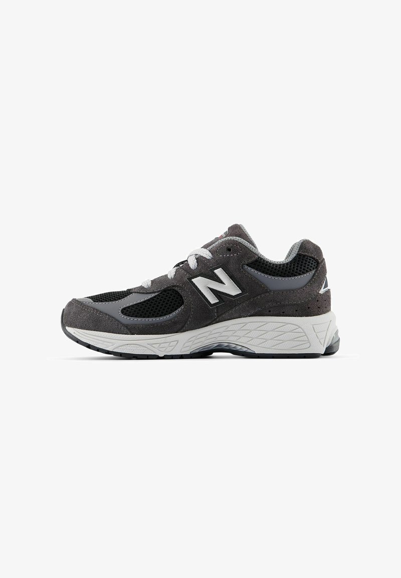 Gray athletic shoe featuring a mesh upper with suede accents, white logo, and textured rubber sole for grip. Classic lace closure.