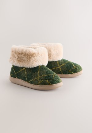 Grüne Hausschuhstiefel mit Muster und einem Besatz aus Kunstfell, ausgestattet mit einem strukturierten Strickdesign und einer beigen Gummisohle.