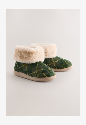 Zöld mintás papucs csizma műszőrmés mandzsettával, texturált kötött mintával és bézs gumi talppal.