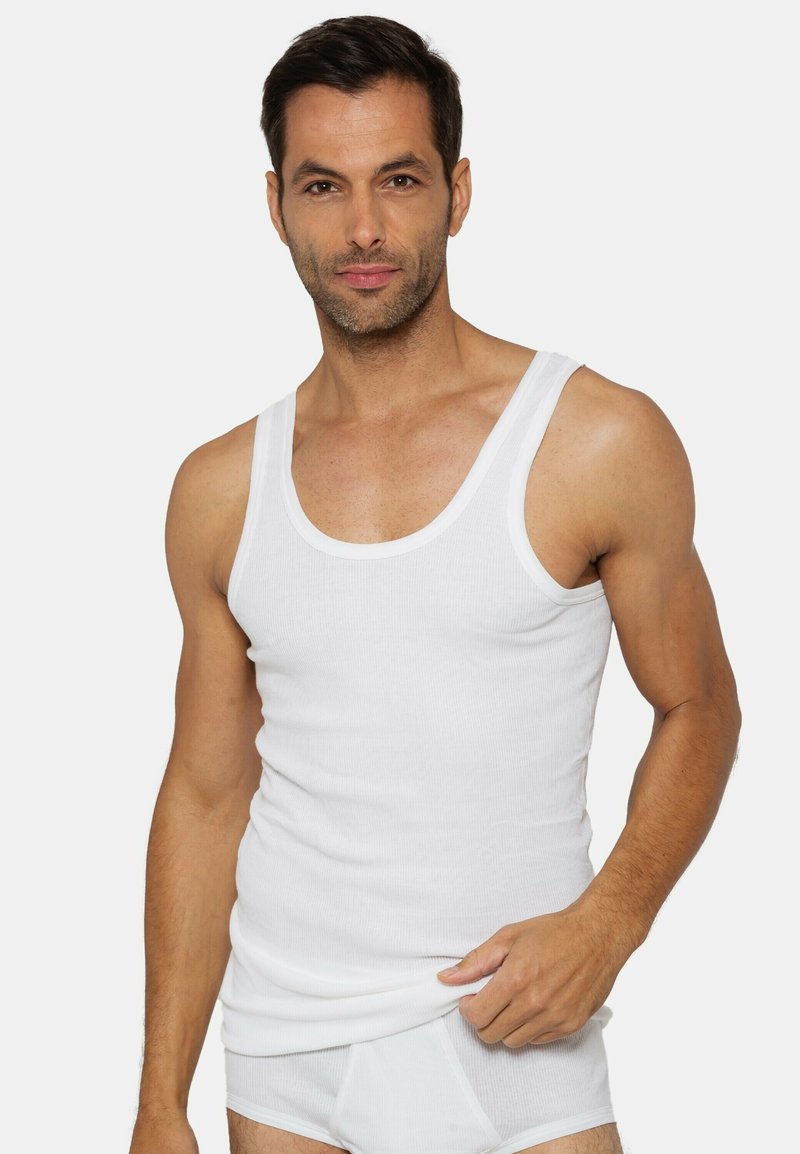 White cotton tank top with a ribbed texture, wide shoulders, and a rounded neckline. Worn with matching white underwear.