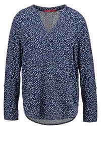 Blouse à manches longues bleu marine avec un motif de points irréguliers bleu clair et blanc, col en V avec trois boutons.