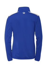 Blå jakke med høj krave og lange ærmer. Har hvide detaljer ved skulderne. Lavet af et glat, letvægtsstof.