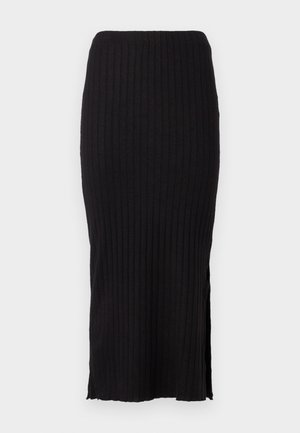 Melna ribota adīta svārku ar taisnu siluetu, sānu šķēlumi apakšmalā un maiga tekstūra ērtai valkāšanai.