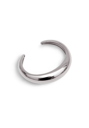 Pulsera tipo cuff en metal plateado pulido, con un diseño suave y redondeado, con extremos abiertos para un tamaño ajustable y un aspecto elegante.