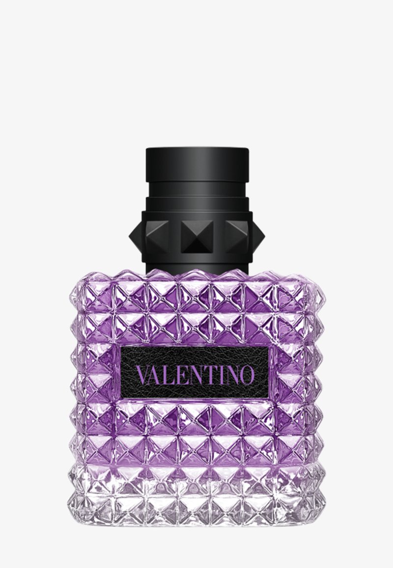 Vierkante heldere glazen parfumfles met gestructureerde piramidevormige studs, paarse vloeistof erin, zwarte gestudeerde dop en Valentino-label aan de voorkant.