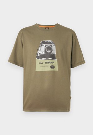 Green cotton t-shirt with short sleeves, featuring a graphic print of a vehicle and text "ALL-TERRAIN" on a square patch.