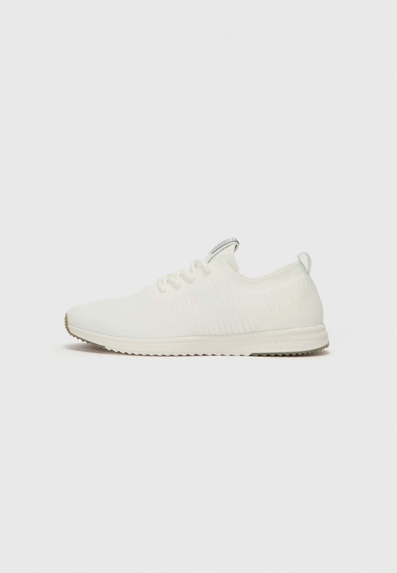 White athletic shoes with a textured, knitted upper, lace-up design, and a lightweight sole. No visible logos or patterns.