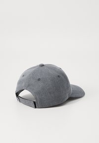 Gray snapback cap with a textured fabric, curved brim, and adjustable strap at the back. Features six ventilation eyelets.