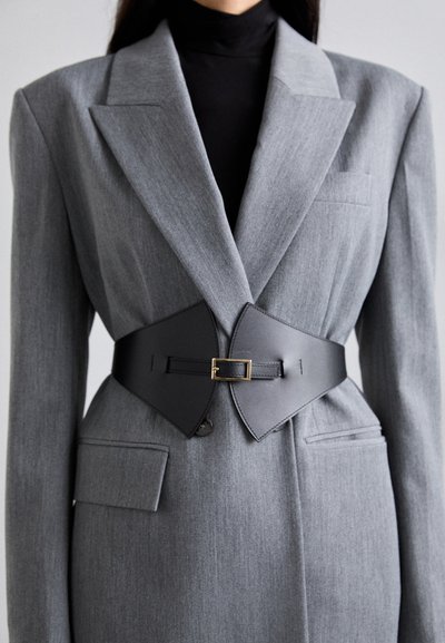 Gray tailored blazer with notched lapels and two front pockets, cinched with a black leather belt featuring a gold buckle.