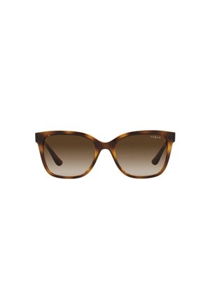 Gafas de sol de carey con lentes marrones degradados. Forma de ojo de gato, montura de plástico y detalle sutil del logo en la parte superior izquierda de la montura.
