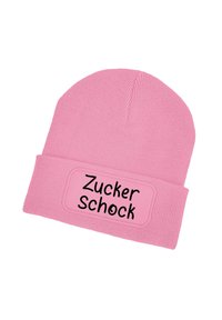 Pink knit beanie with a folded cuff, featuring a rectangular patch displaying "Zucker Schock" in black, smooth texture.