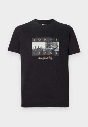 Black cotton t-shirt featuring a graphic with two vintage-style photos and the text "TOMMY JEANS" and "New York City" in gold accents.