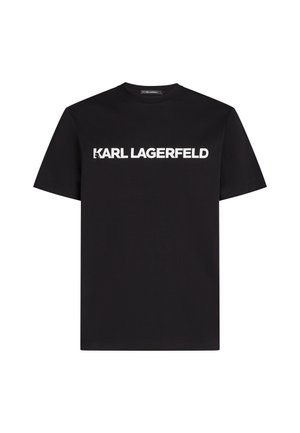 Musta puuvillapaita lyhyillä hihoilla, jossa on valkoinen "KARL LAGERFELD" -logo rinnan kohdalla lihavoidulla, isolla kirjasimella. Normaali malli.