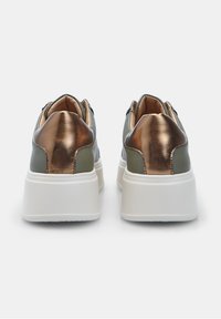 Green and bronze metallic sneakers featuring a thick white sole, smooth leather texture, and padded collar detail.