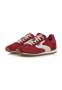 Sneakers atletici rossi con accenti bianchi, materiali in suede e tessuto, punta rotonda, suola in gomma e lacci grigi chiari. Dettaglio verde sul tallone.