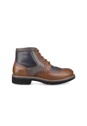 Men's leather brogue ankle boot in brown, gray, and black with decorative perforations and a black rubber sole.