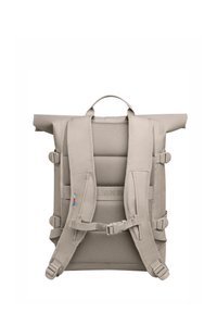 Mochila de color gris claro con tapa enrollable, espalda de malla, correas acolchadas, hebillas ajustables y un asa en la parte superior. Presenta un logotipo en la correa.